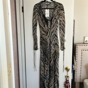 Zara animal print dress. Never worn. Has hole in front but could be repaired.